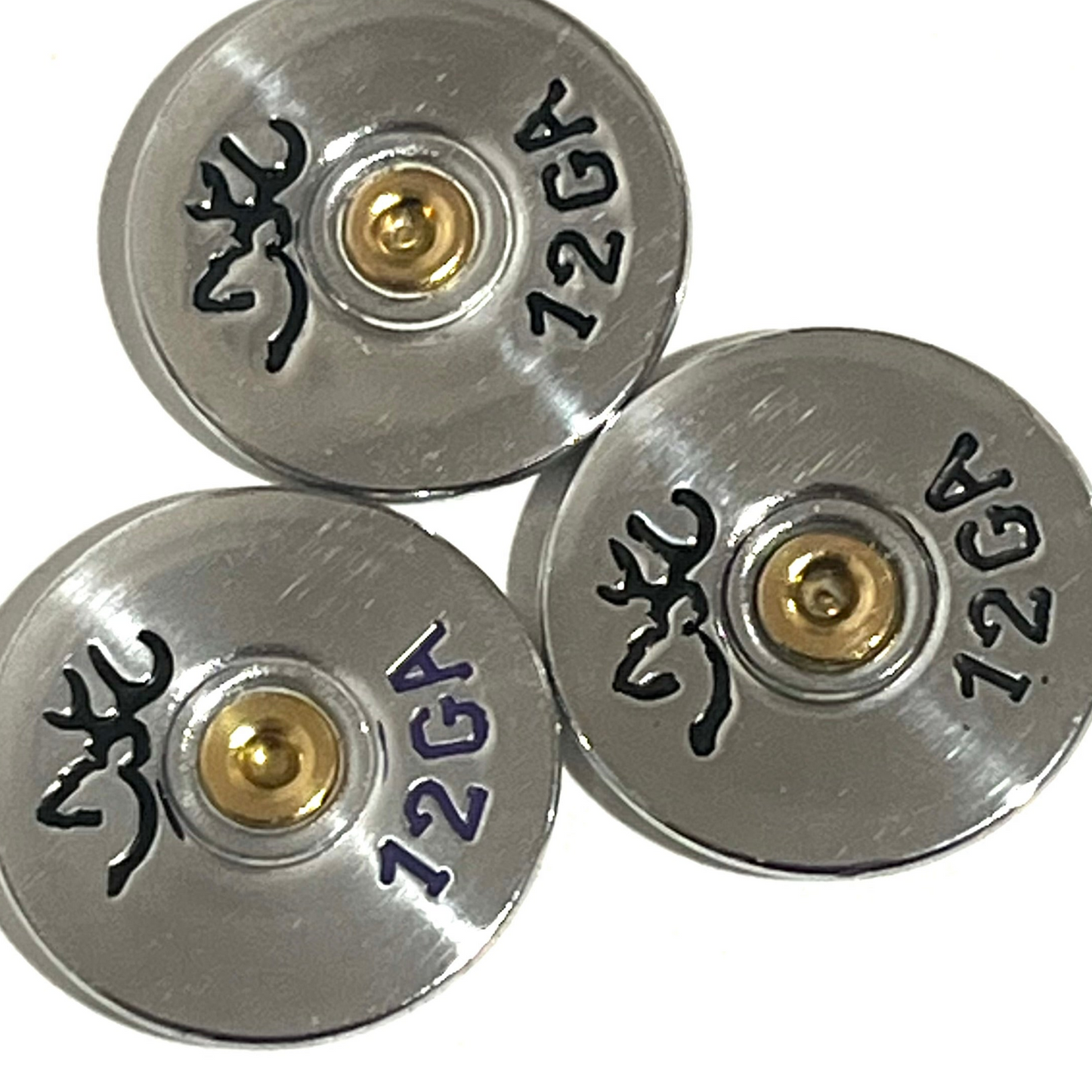 Three overlapping silver Browning 12 gauge shotgun shell slices on white