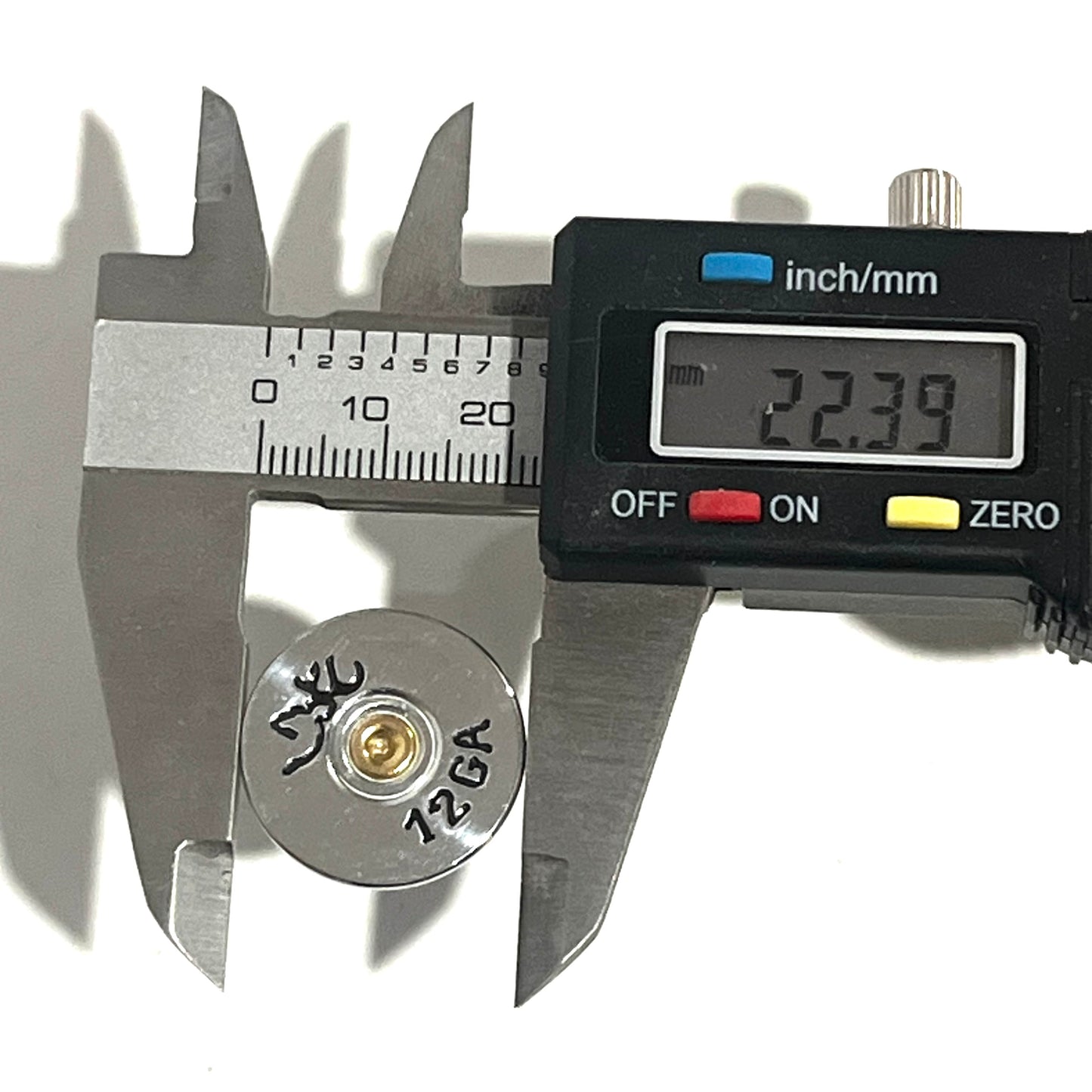 Digital caliper measuring a Browning shotgun shell slice at 22.39 mm across