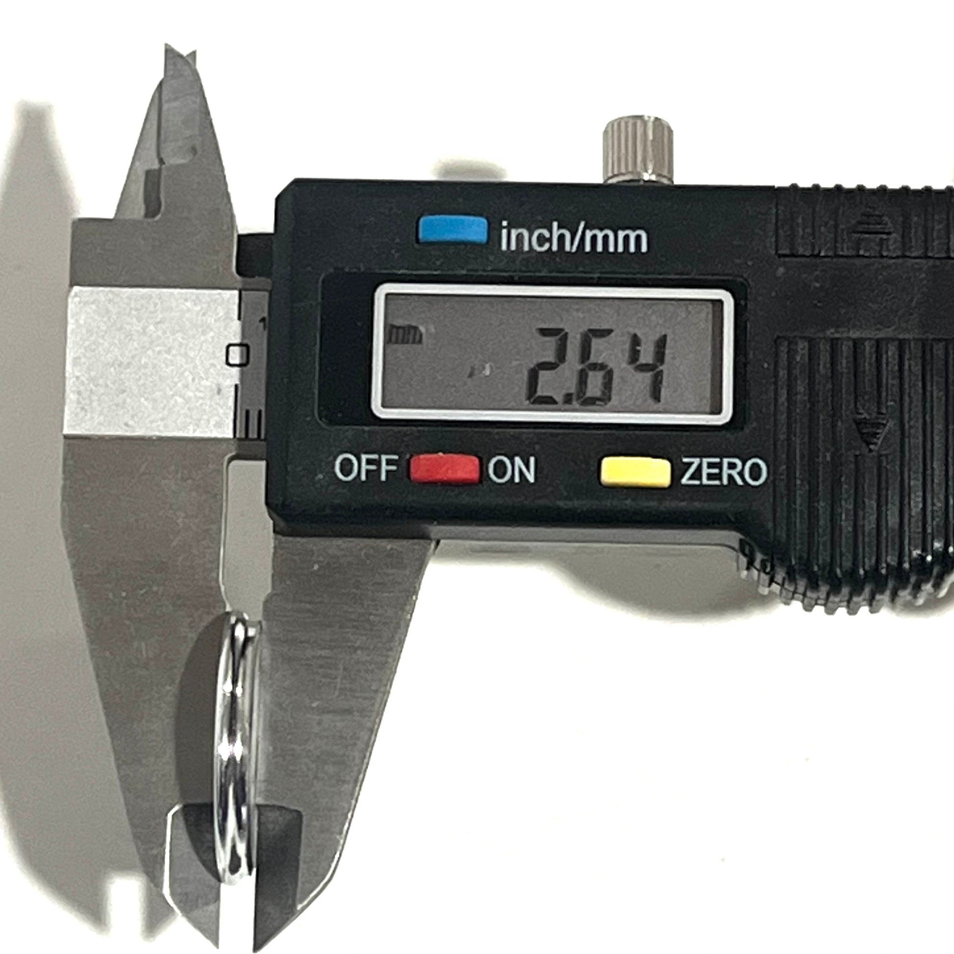 Digital caliper measuring the edge thickness of a shotgun shell slice at 2.64 mm