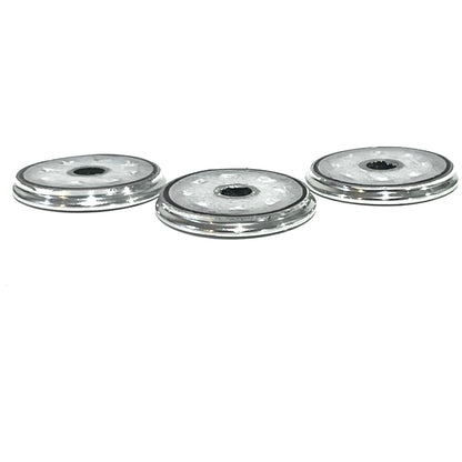 Side profile of three silver Browning shotgun shell slices showing thin edges and center openings