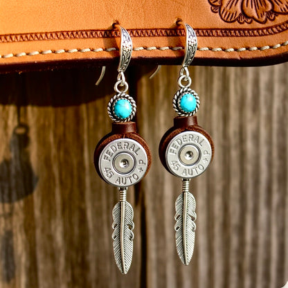 Two bullet slice earrings with turquoise beads and silver feathers, showcasing Federal 45 Auto headstamps.