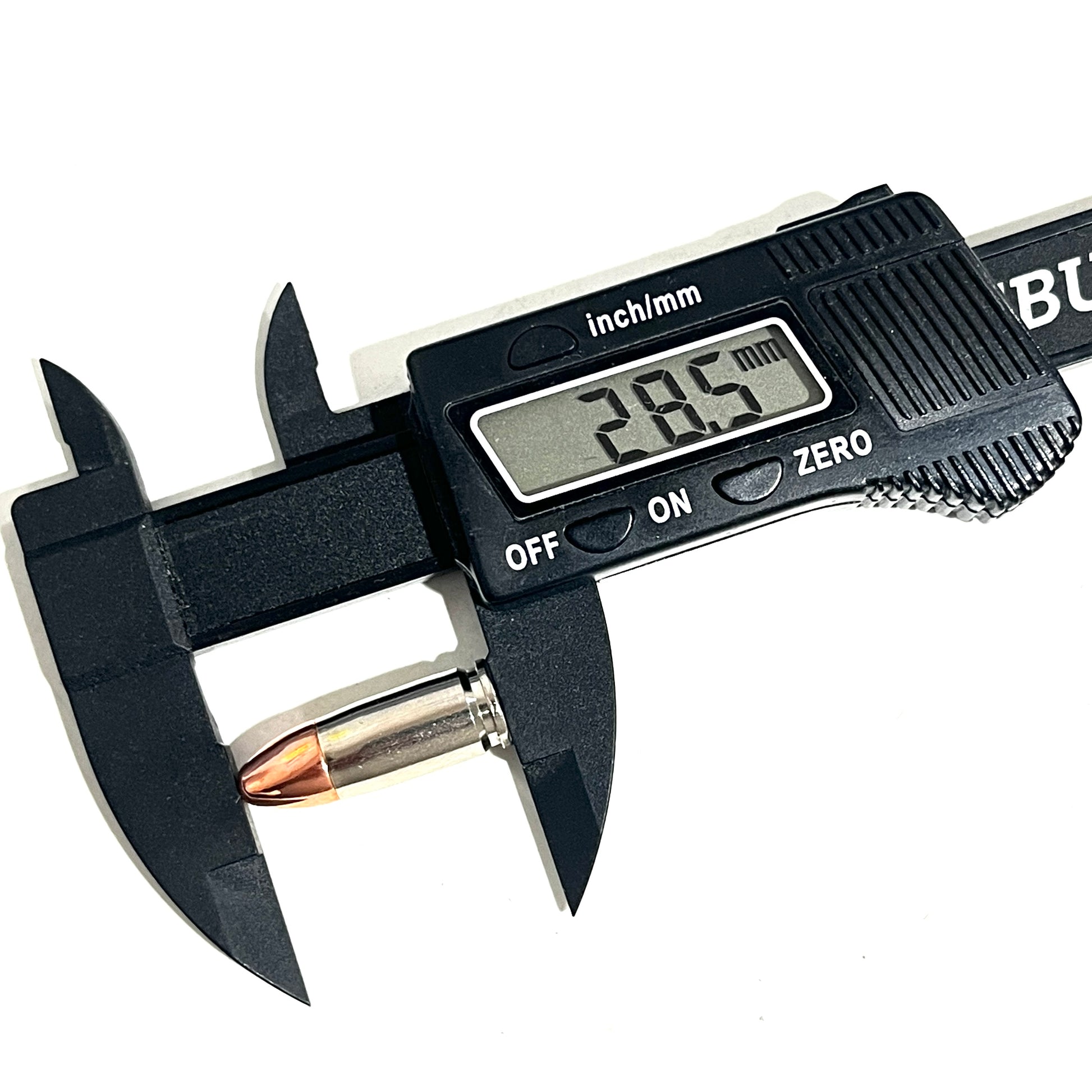 A black digital caliper measuring the overall length of a nickel 9mm dummy casing, reading 28.5 mm.
