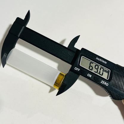Digital caliper measuring the full length of a clear, empty 12 gauge hull at 69.0 mm