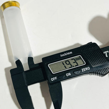Digital caliper reading 19.3 mm across the plastic body of a clear, empty 12 gauge shotshell with a brass head