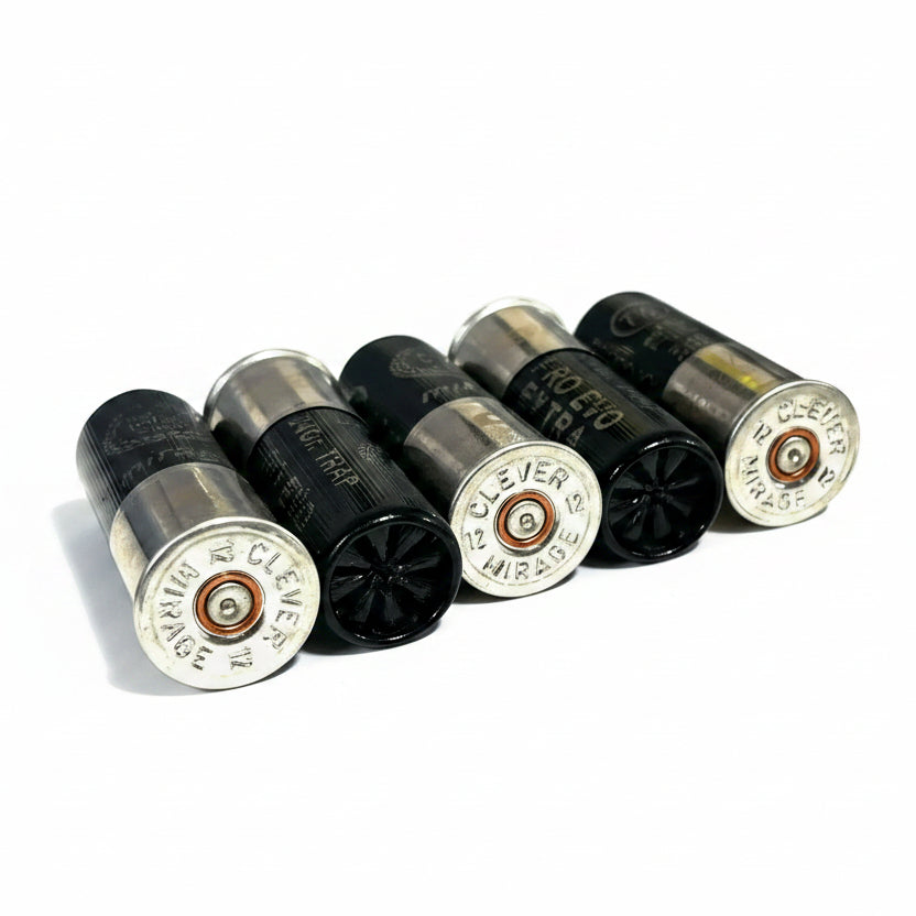 Five 12-gauge casings angled together, showing legible "CLEVER MIRAGE" headstamps and brass primer centers.