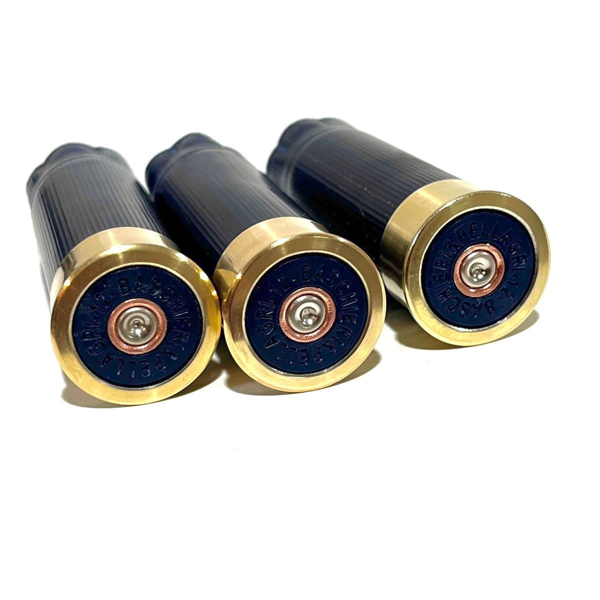 Three dark blue 12 gauge shotgun shells with gold bases showing headstamps on white background