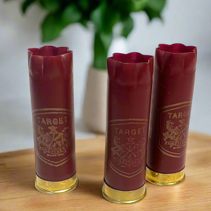 Three Dark Red Herter's Empty Shotgun Shell Hulls Standing