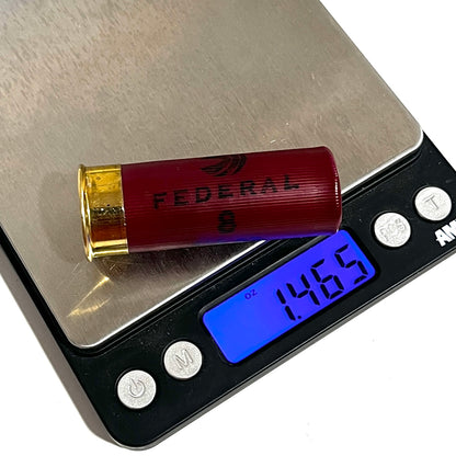 Single dark red Federal 12 gauge weighted dummy round on a digital scale reading 1.465 oz