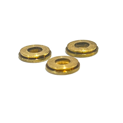3 gold deprimed bullet slice rings viewed from an angle on a white background