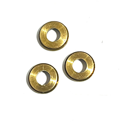 3 gold deprimed bullet slice rings arranged in a triangle on a white background