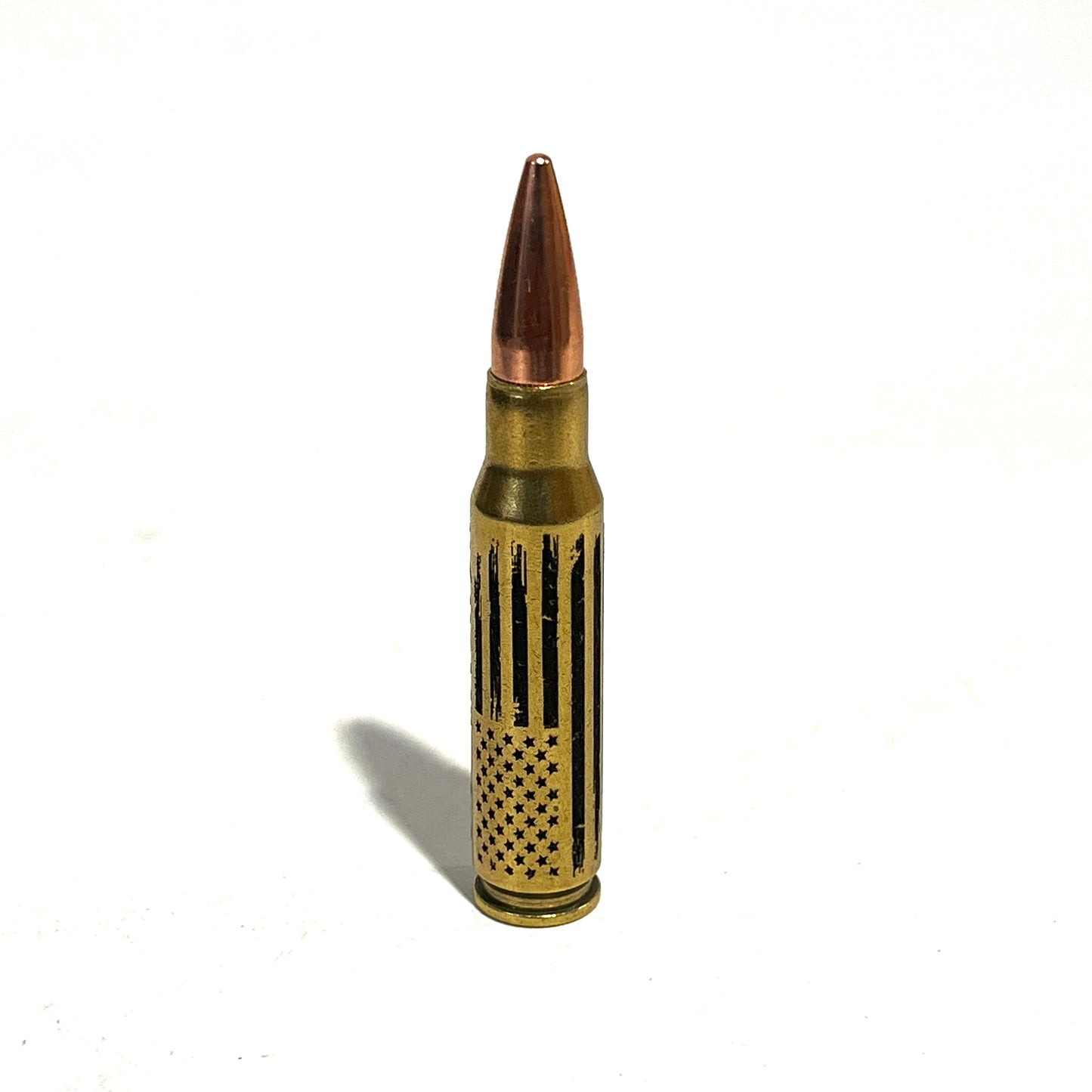 308 Win dummy round featuring a vertical distressed American flag engraving on authentic once-fired brass casing.

