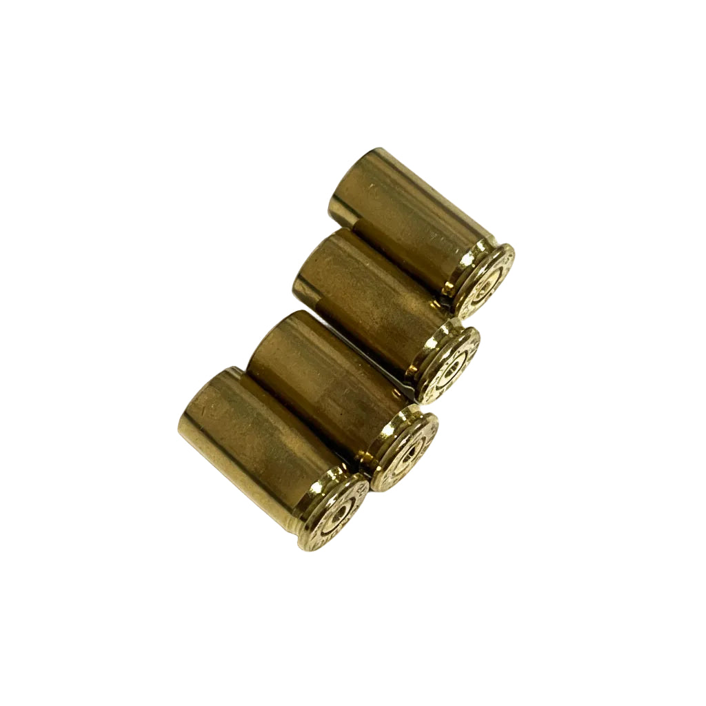 Four drilled .32 Auto brass casings resting at an angle on white showing gold bodies, base rims, and open mouths.