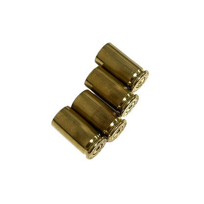 Four drilled .32 Auto brass casings resting at an angle on white showing gold bodies, base rims, and open mouths.