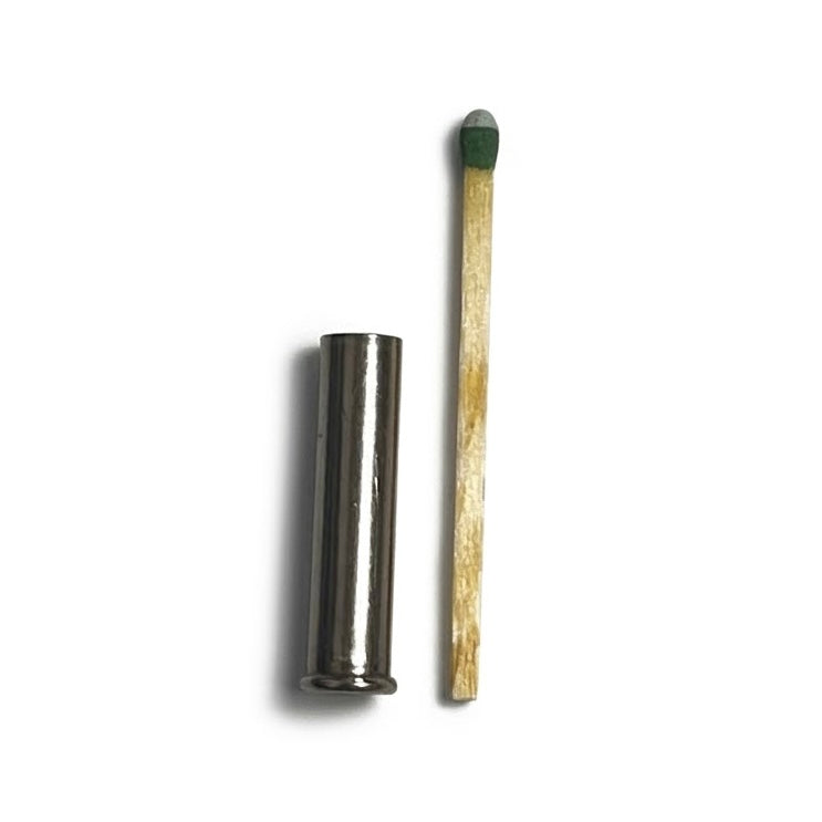 A match stick next to a drilled 22 nickel spent case for size reference for bullet jewelry