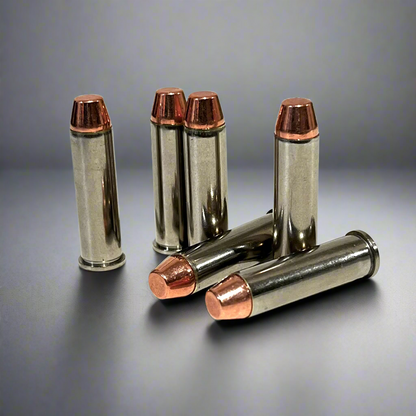Five nickel display cartridges with copper flat nose bullets, three standing upright and two lying down on a reflective gray background.