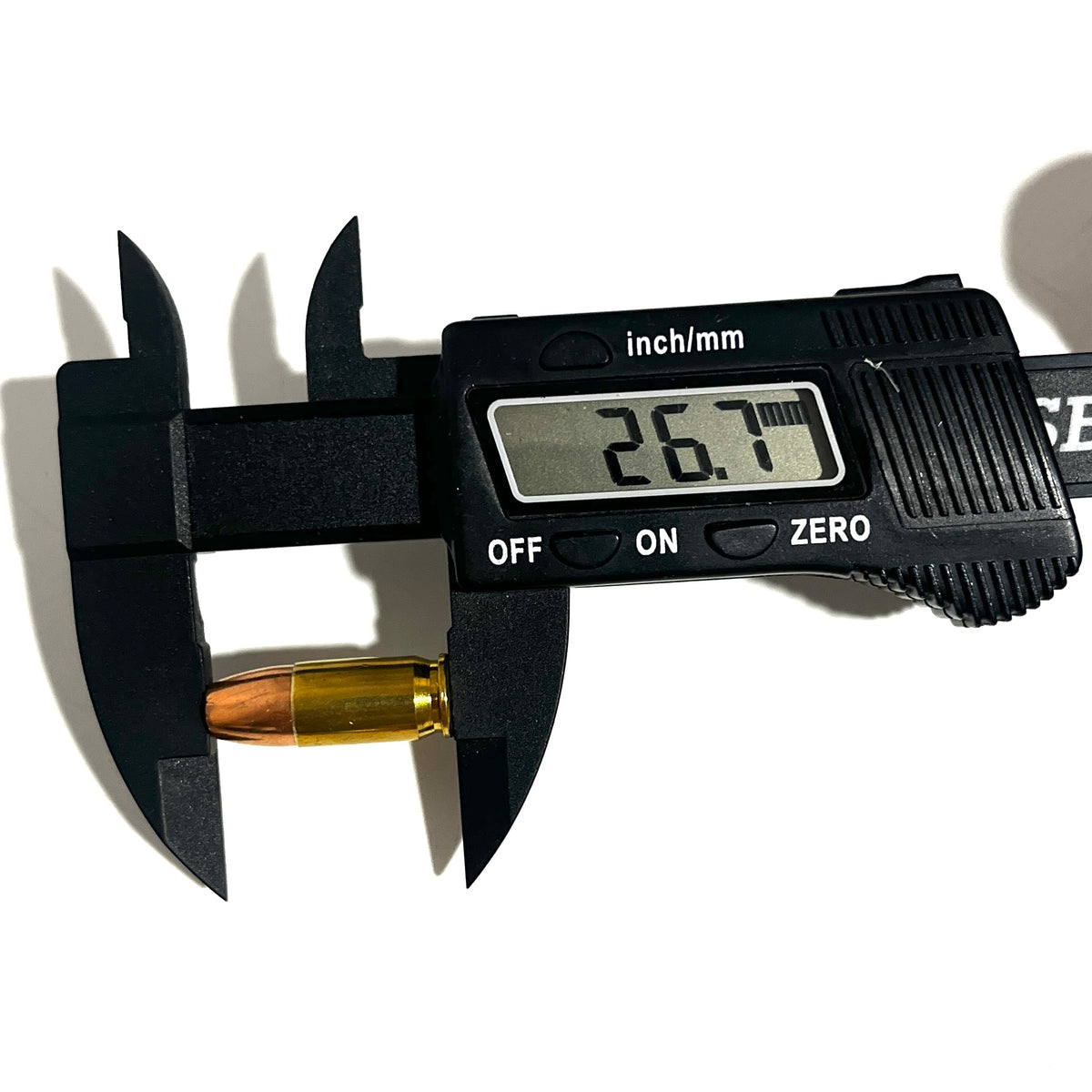Digital caliper measuring the length of a dummy .380 Auto round at 26.7mm