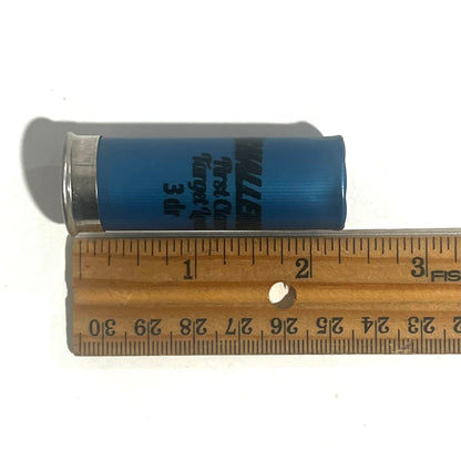 A blue Challenger First Class Target Load shotgun shell beside a ruler showing a length of about 2.75 inches