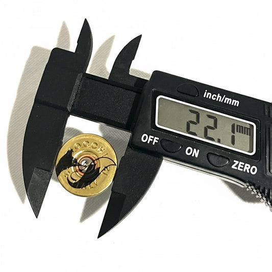 Digital caliper measuring the diameter of a gold engraved fox shotgun shell slice at 22.1 millimeters