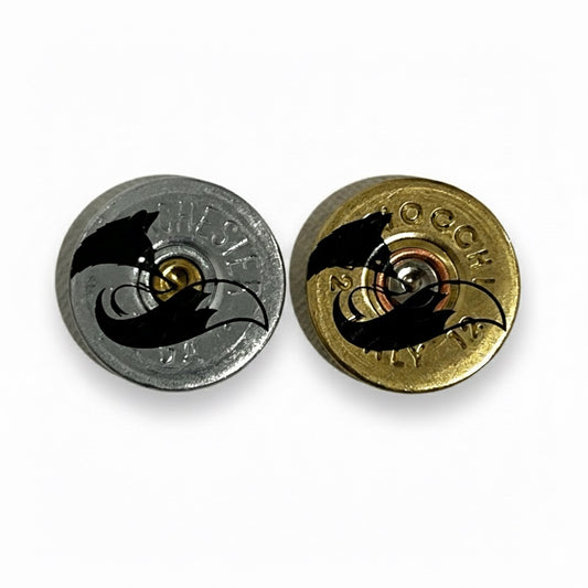 Two shotgun shell slices, one silver and one gold, each with a black engraved fox silhouette on a white background