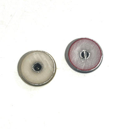 2 round shotgun shell slices viewed from the underside showing white enamel-lined centers, one with gray edging and one with red edging