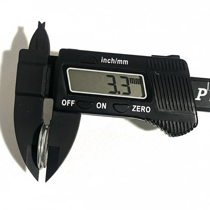 Digital caliper measuring the thickness of a shotgun shell slice at 3.3 millimeters