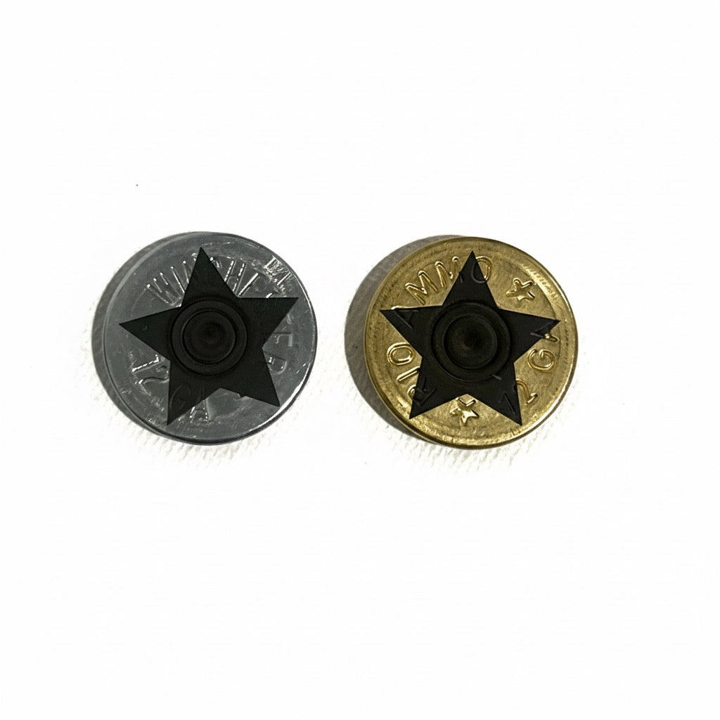 Two shotgun shell slices, one silver and one gold, each with a black engraved star design on a white background