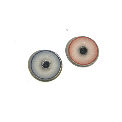 2 round shotgun shell slices viewed from the underside showing white enamel-lined centers with blue and red edging
