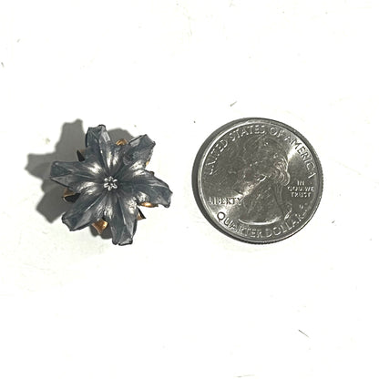 Single .45 ACP expanded hollow point bullet blossom flower charm shown next to a US quarter for size reference