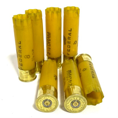 Federal 20 gauge empty shotgun shells, yellow hulls in an array for making western-themed shadow box art.
