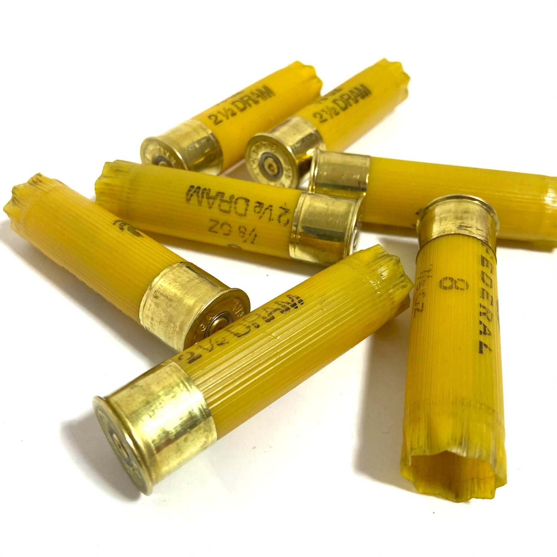 Federal 20 gauge empty shotgun shells, yellow plastic hulls for creating unique holiday garland or rustic crafts.
