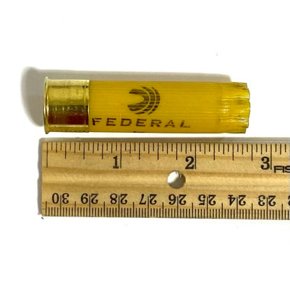 Federal 20 gauge empty shotgun shells, yellow plastic hull next to a ruler showing size for craft planning.
