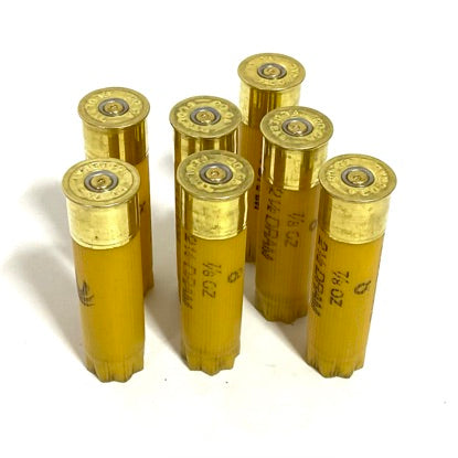 Federal 20 gauge empty shotgun shells, yellow plastic cases standing upright for ammo-themed party decorations.
