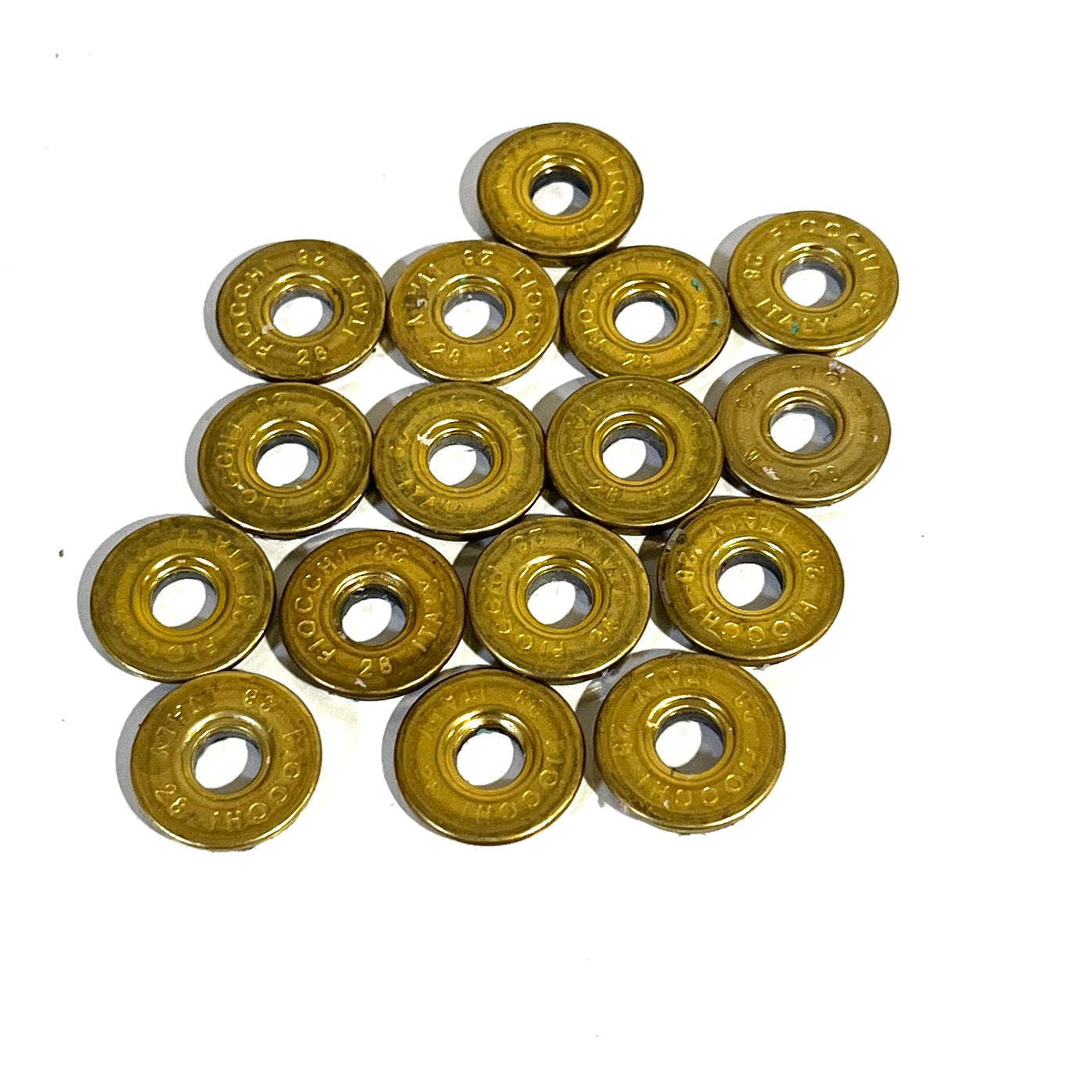 15 gold brass Fiocchi 28 gauge shotgun shell slices arranged in a cluster on a white background