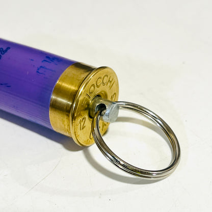 Close-up of the Fiocchi 12 gauge brass head with stainless swivel pin and nickel-free split ring on a lavender shell keychain