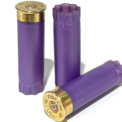 Three light purple shotshells with brass heads stamped Fiocchi 12 USA, one showing an open crimped top