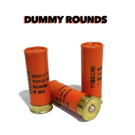 Three Fiocchi orange 12 gauge dummy rounds under a bold Dummy Rounds text banner, gold bases visible.