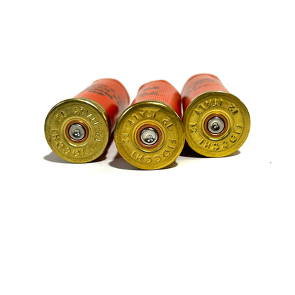 Three used Fiocchi 12 gauge shell headstamps showing stamped primers on brass bases.