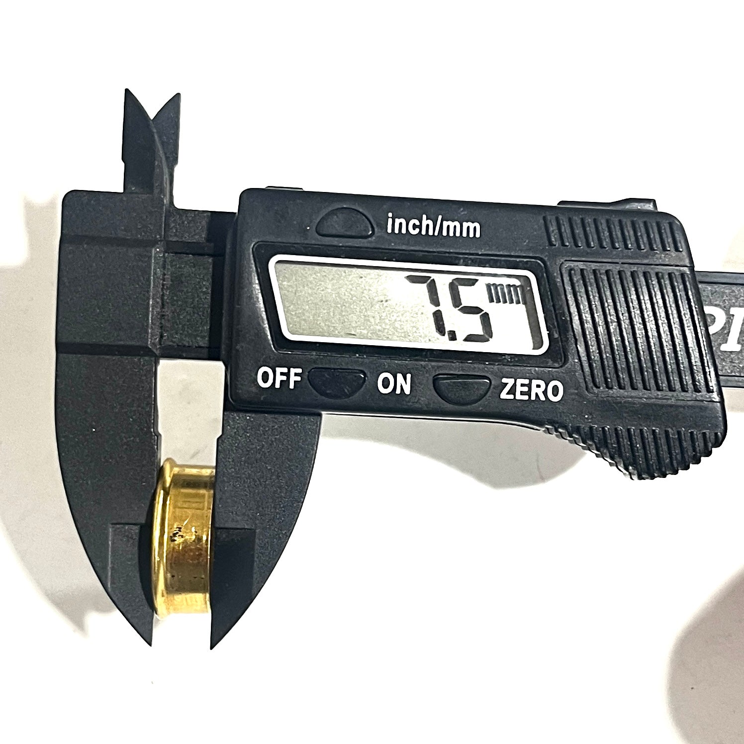 Gold Fiocchi 12 gauge deprimed shell bottom measured with a digital caliper reading 7.5 millimeters.