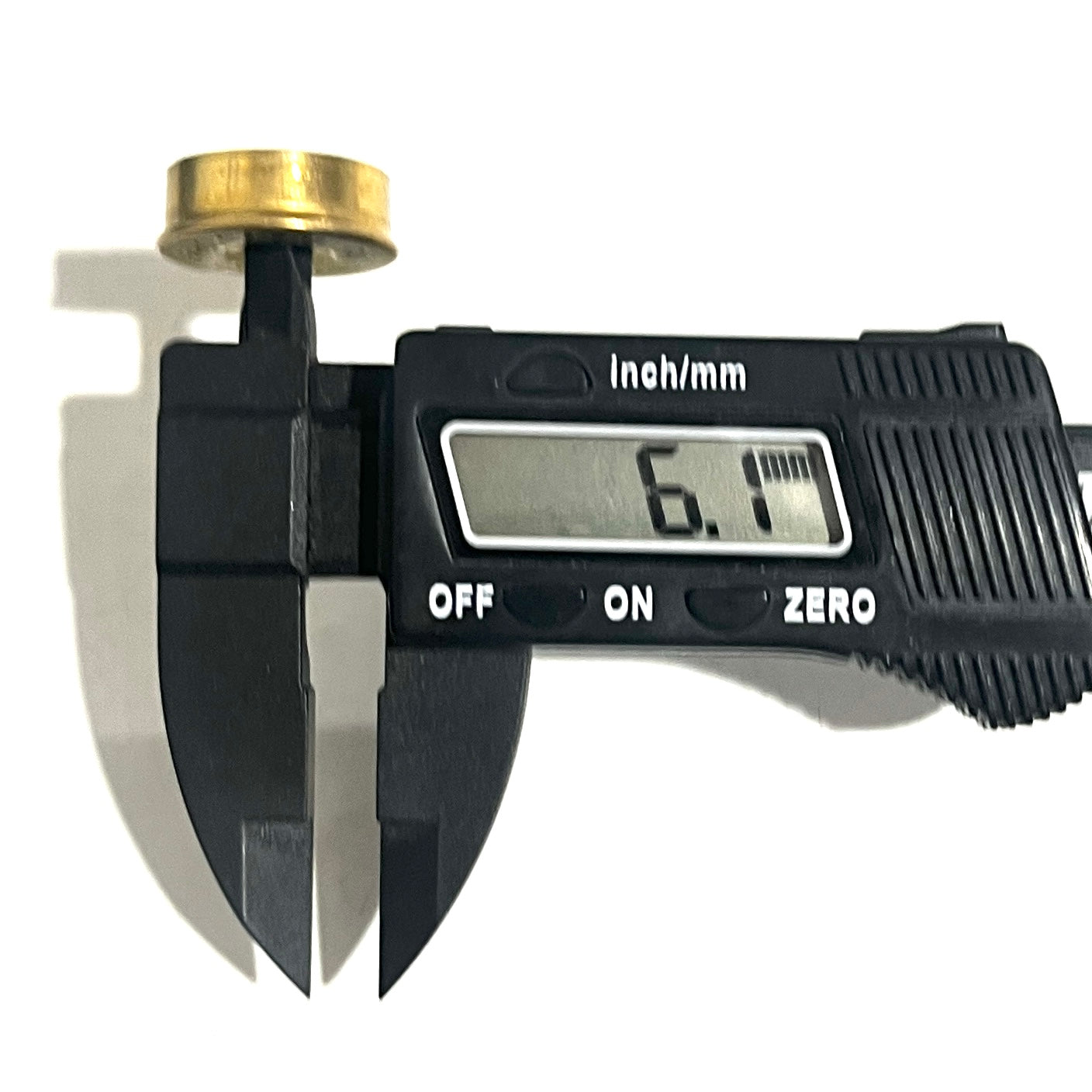 Gold Fiocchi 12 gauge headstamp primer hole measured with a digital caliper reading 6.1 millimeters thick.