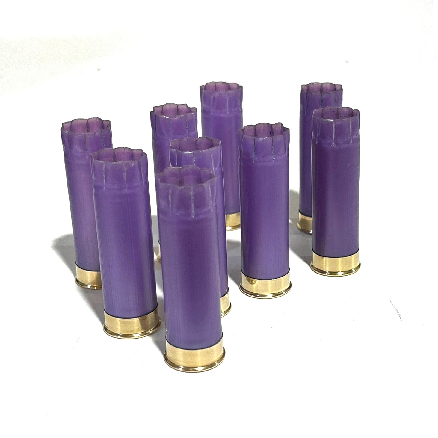 Eight light purple shells standing upright with open crimped tops and gold bases on a white background