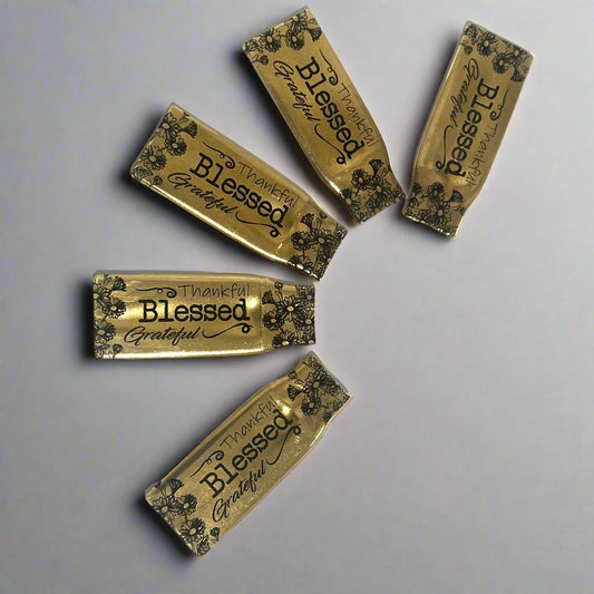 Five flattened .308 brass casings with floral Thankful, Blessed and Grateful engraving