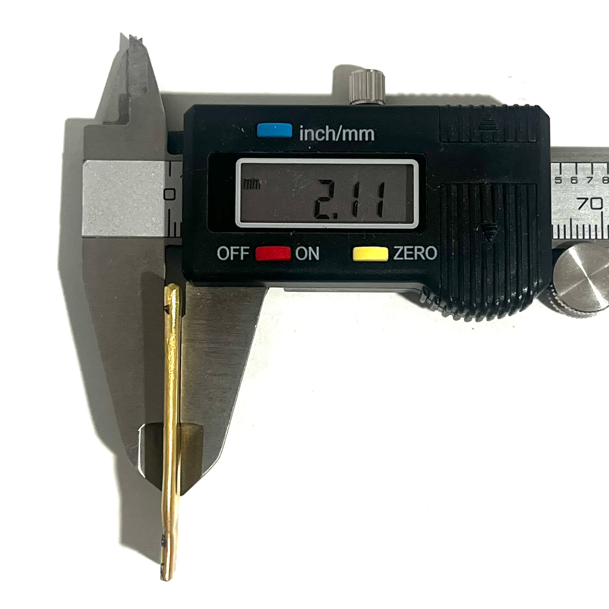 Digital caliper measuring a flattened .308 brass casing at 2.11 millimeters thick