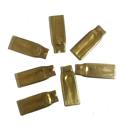 Unengraved reverse sides of seven flattened .308 brass casing pieces showing differences in shape and surface