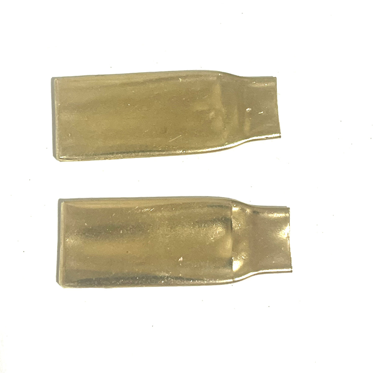 2 blank flattened brass .308 casings without engraving, stacked on a white background