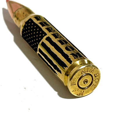 Brass .308 round lying on its side showing '308 WIN' headstamp markings and an empty primer pocket