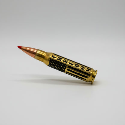 Brass .308 round with red tip lying diagonally on white, engraved with 'FREEDOM' text and flag stripes