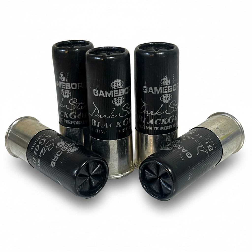Five black Gamebore Dark Storm Black Gold 12-gauge dummy rounds high brass clustered together