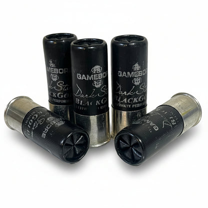 Five black Gamebore Dark Storm Black Gold 12-gauge dummy rounds high brass clustered together