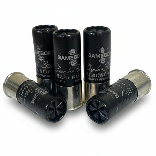 Five black Gamebore Dark Storm Black Gold 12-gauge dummy rounds high brass clustered together