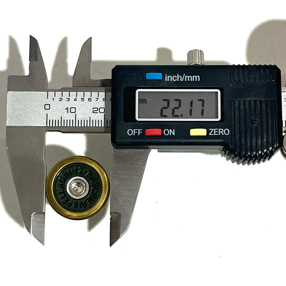 Digital caliper measuring the diameter of a brass Baschieri Pellagri shotgun shell slice showing 22.17 mm